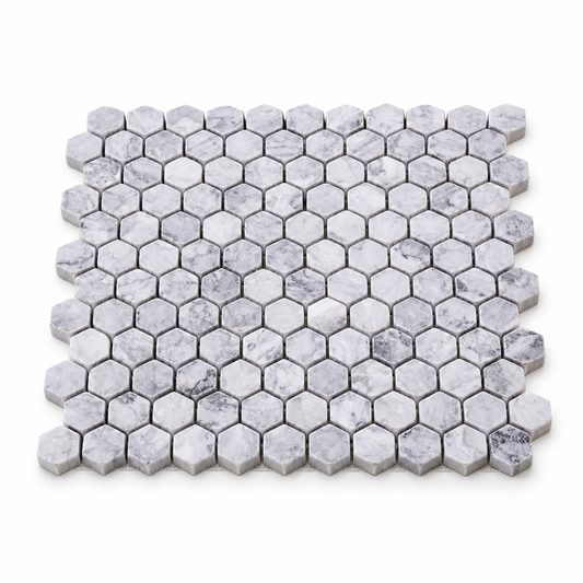 Platinum Grey Tumbled Marble Hexagon Mosaic Tiles — angled sheet showing natural stone edges and mesh backing