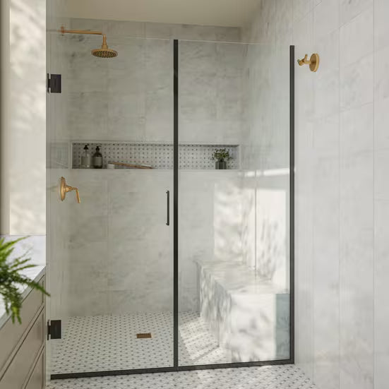 Modern bathroom with a glass shower enclosure, gold fixtures, and white tiled walls.