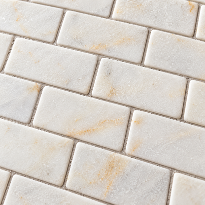 Calacatta Sugar Tumbled Marble Brick Mosaic Tiles 50x100: close-up of the natural stone texture, pattern and grout joints