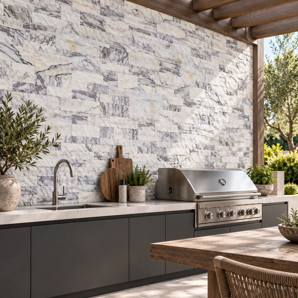 Calacatta Viola split face marble wall cladding behind a barbecue and sink in an outdoor kitchen visualisation.