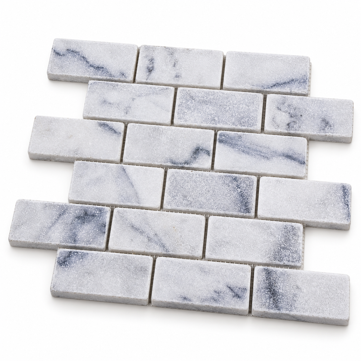 Carrara White Tumbled Marble Brick Mosaic Tile 50x100 — angled sheet showing 10 mm natural marble edges and mesh backing