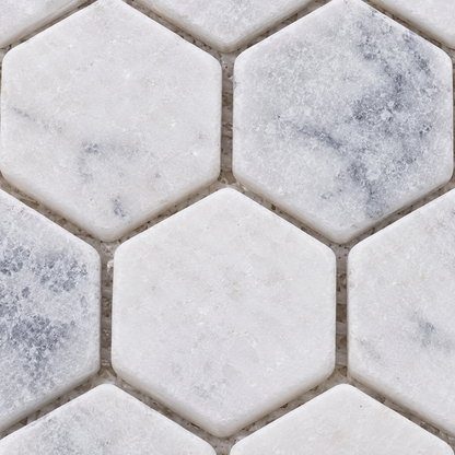 Carrara White Tumbled Marble Hexagon Mosaic Tile 23x23 — macro close-up of natural marble texture, finish and mosaic chip detail