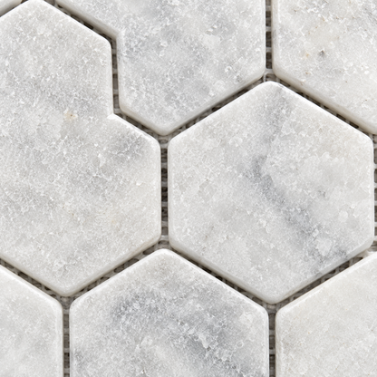 Carrara White Tumbled Marble Hexagon Mosaic Tile 48x48 — macro close-up of natural marble texture, finish and mosaic chip detail