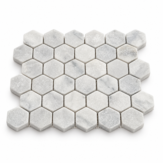 Carrara White Tumbled Marble Hexagon Mosaic Tile 48x48 — angled sheet showing 10 mm marble edges and mesh backing