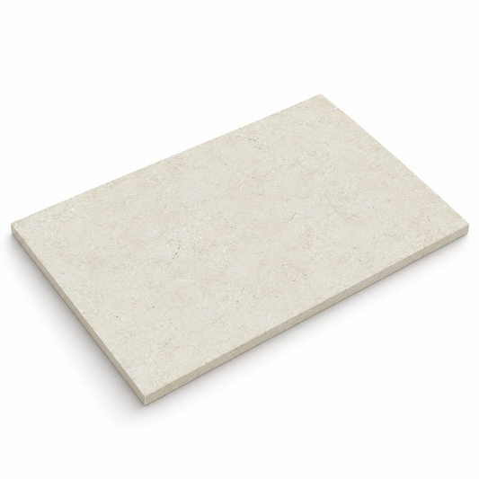 Angled view of a Galala Ivory honed limestone 900 x 600 x 15 mm tile showing its smooth matt face and sawn edge.