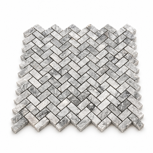 Platinum Grey Honed Marble Herringbone Mosaic Tiles — angled sheet showing natural stone edges and mesh backing