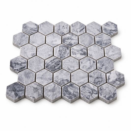 Platinum Grey Tumbled Marble Hexagon Mosaic Tile 48x48 — angled sheet showing natural stone edges and mesh backing